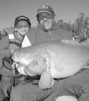 Young Jock Mackenzie admires a very nice cod taken in the Murray by his Dad on a white Bassman spinnerbait. Will the fresh flow from Queensland help revive the Murray? Only time will tell.